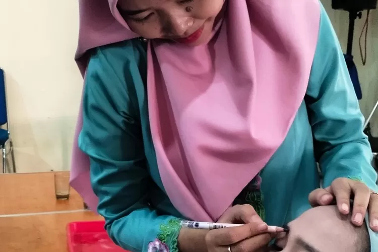Salah satu peserta sedang mencoba merias wajah yang dihelat Seksi Ekbang Kelurahan Limo, Kamis (18/7). (ALDY/RADAR DEPOK)
