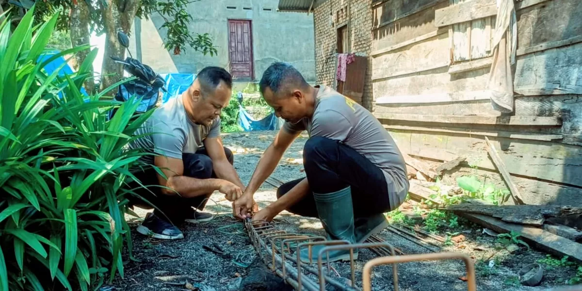 Diguyur gerimis, personel Sat Brimob Polda Sumut tetap menunjukkan dedikasi dan kepedulian terhadap masyarakat dengan melaksanakan pembangunan rumah bagi warga korban banjir di Desa Tolang Julu, Kecamatan Sayur Matinggi, Kabupaten Tapsel, Sabtu (7/2/2026).(Foto : Realitasonline/ Ogek)