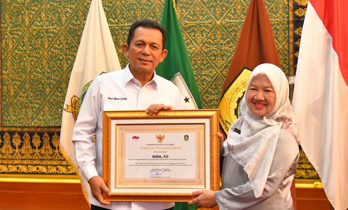 Gubernur Kepri Ansar Ahmad menyerahan piagam penghargaan kepada Kepala Perwakilan BKKBN Provinsi Kepri, Rohina yang akan pindah tugas.(Foto:Diskominfo Kepri)