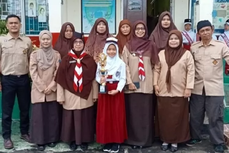 Dhavita Nur Maulida (Pegang piala) berfoto bersama kepada guru di halaman SDN Cimpaen 3, yang terletak di Jalan Inpres, Kelurahan Cimpaeun, Kecamatan Tapos, Depok. (DOKUMEN SEKOLAH)